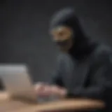 Masked person typing on a laptop